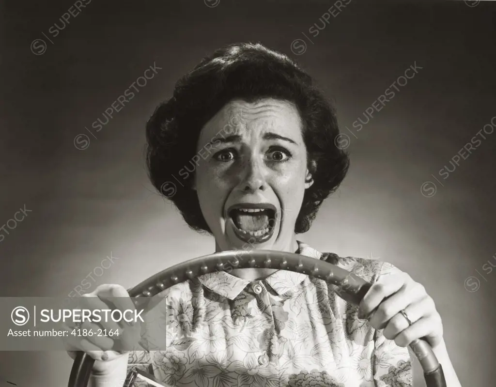 1950S Screaming Frightened Woman Holding On To Steering Wheel Driving Car 
