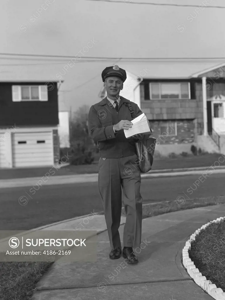 1950S 1960S Mailman Walking Outside Carrying Mail