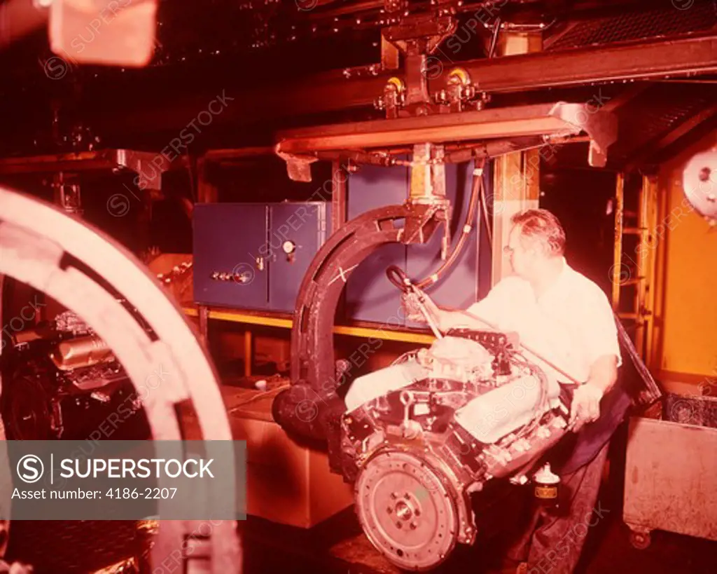 1960S Motor Factory Assembly Line Worker Adjusting Engine