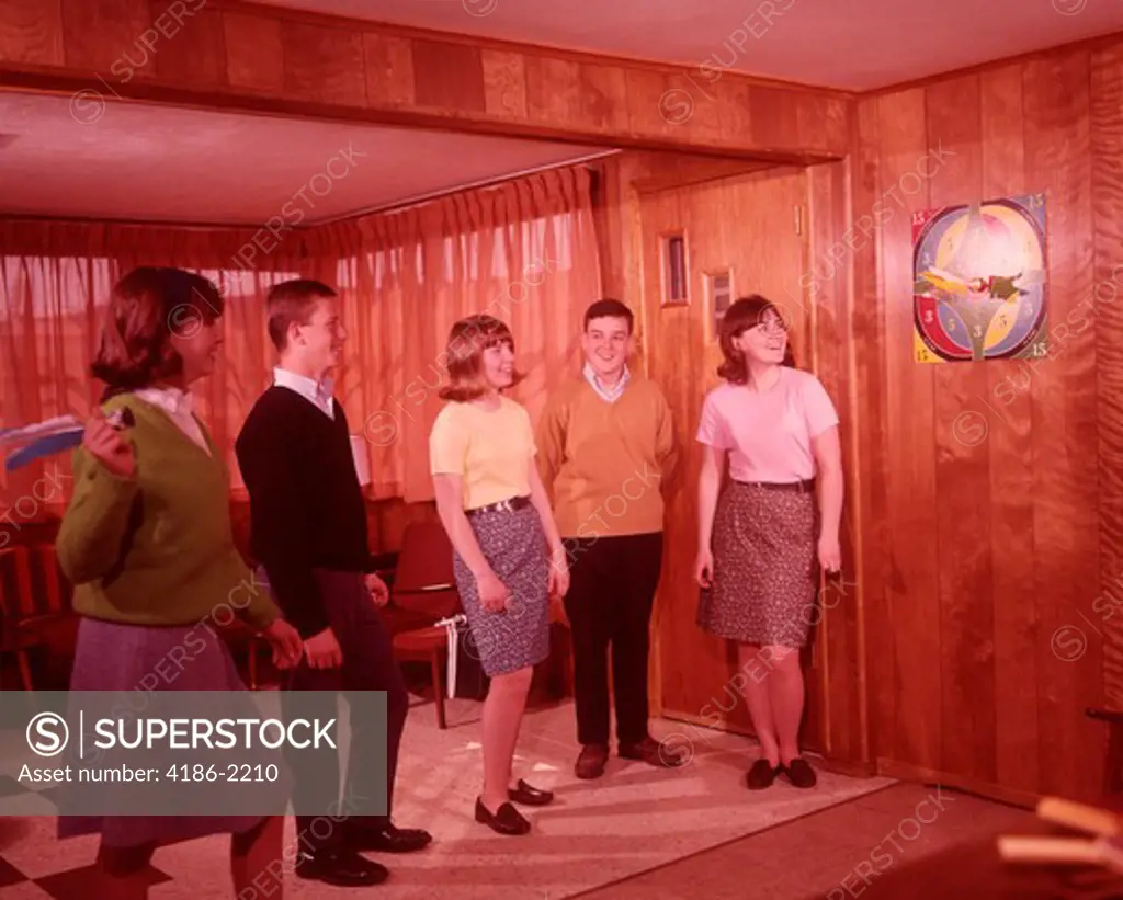1960S Group Of Teens Throwing Darts At Dartboard