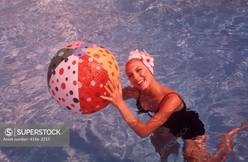 1960S Woman In Swimming Pool Holding Beach Ball