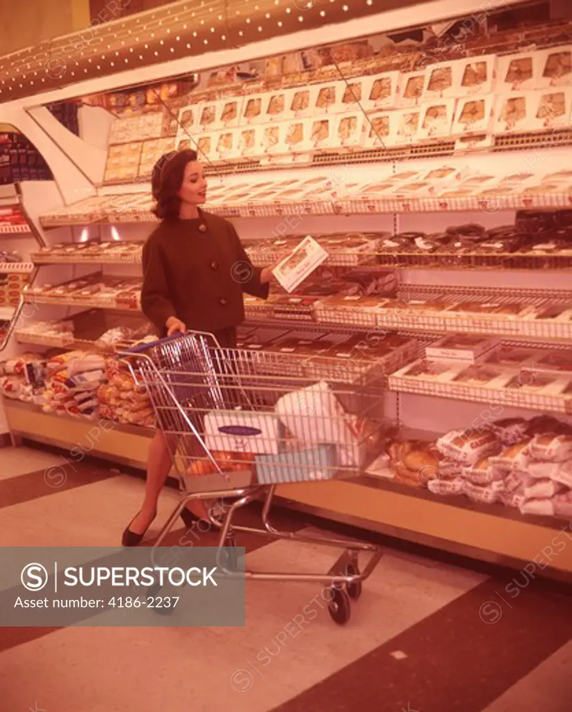 1960S Woman Looking At Supermarket Baked Goods