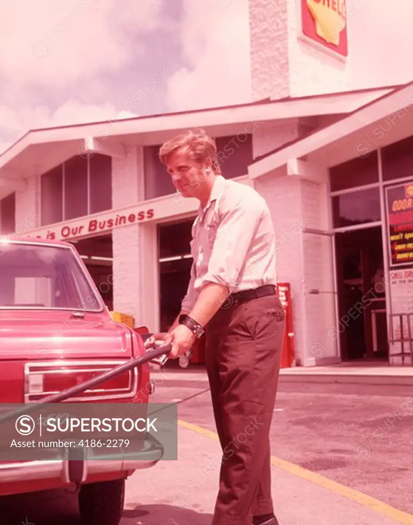 1960S Red Car At Pumps With Gas Station Attendant