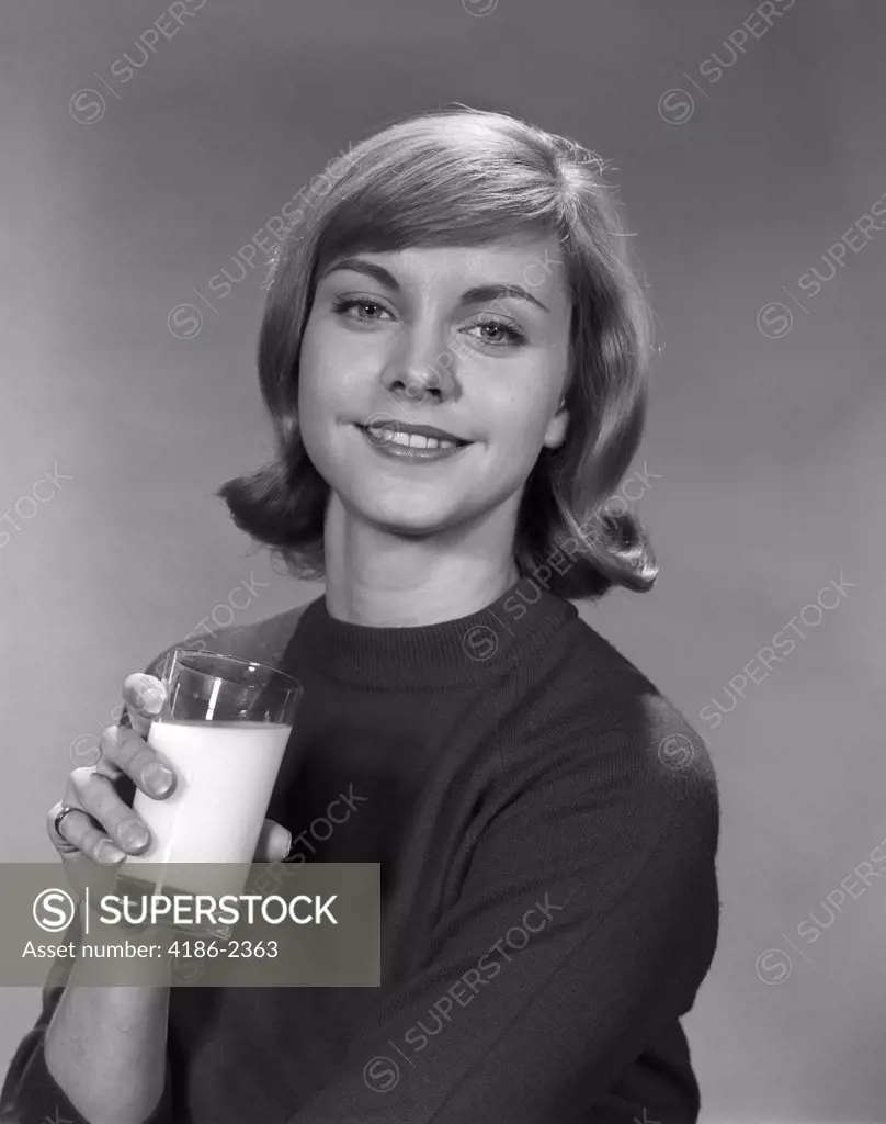 1960S Young Smiling Woman Holding A Glass Of Milk