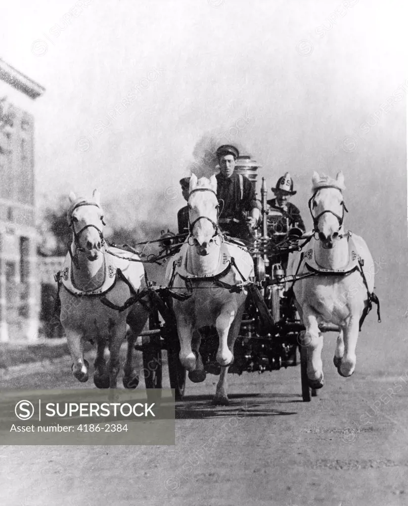 Old-Time Head-On Shot Of Horse-Drawn Fire Truck Racing Down Street