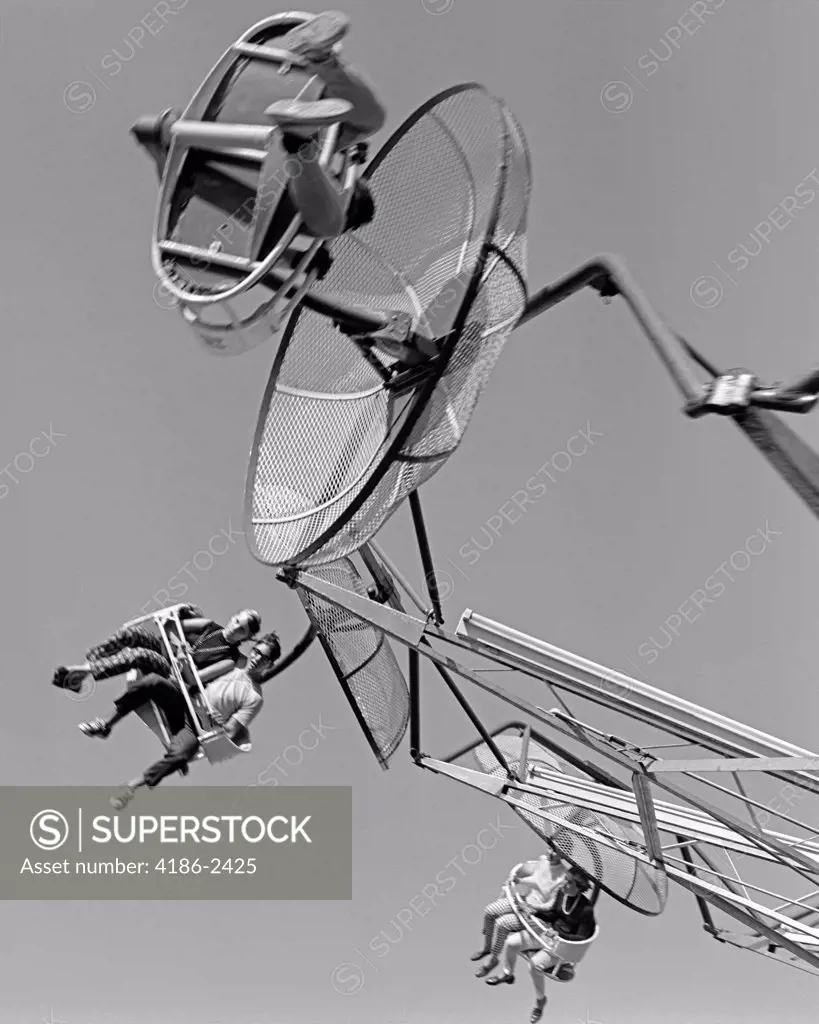 1960S Shot Of 3 Couples Seated On Moving Amusement Park Parachute Ride
