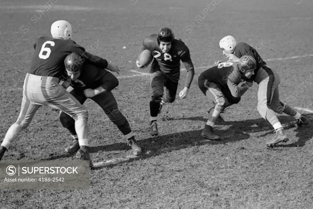 1940S 1950S Football Player Running With Ball As Blockers Defend Him