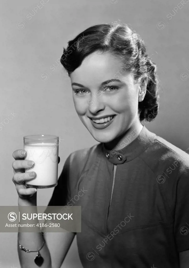 1950S Portrait Smiling Woman Holding A Glass Of Milk Studio
