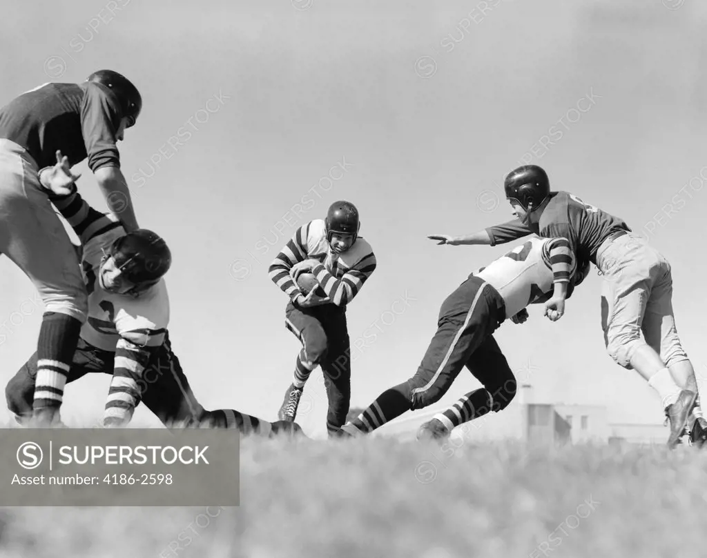 1940S Football Players Blocking Clearing Path For Player With Ball