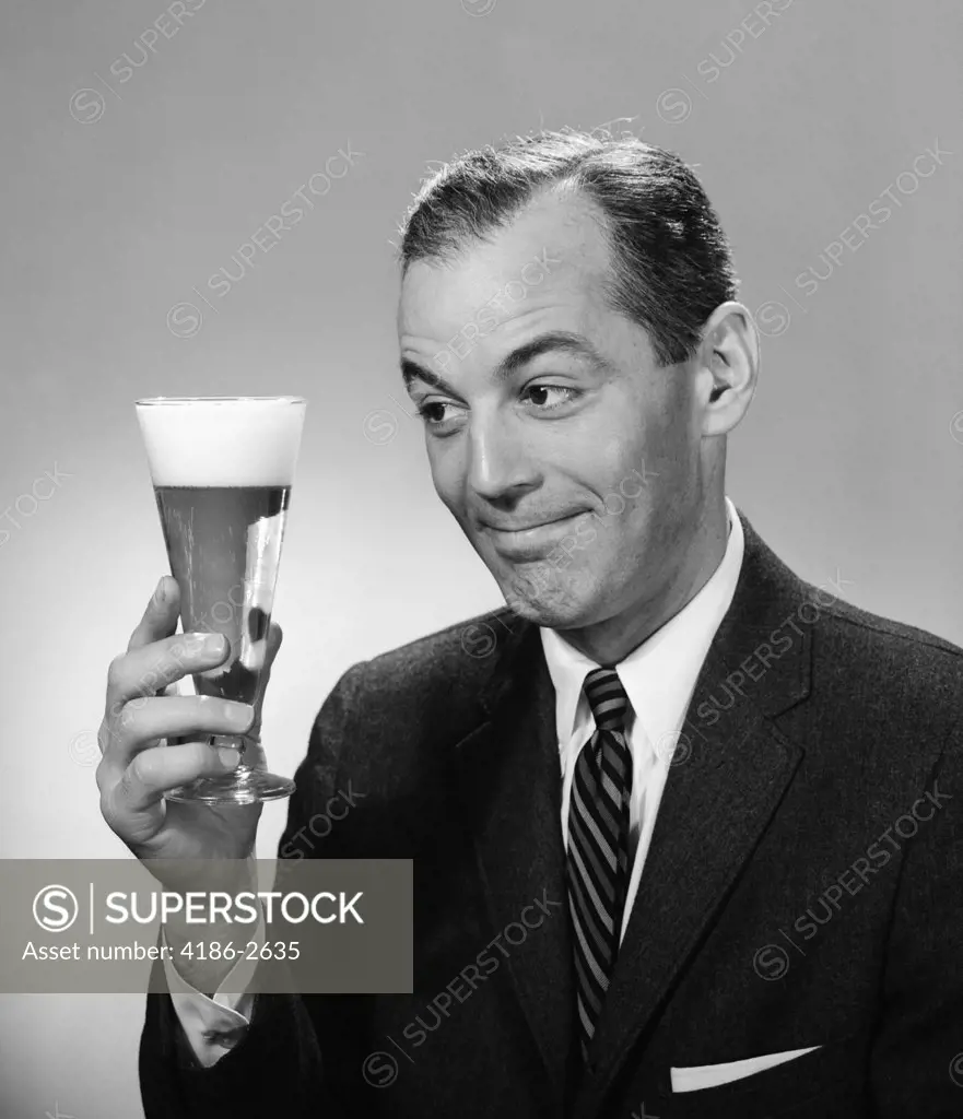1960S Smiling Man In Suit And Tie Holding Looking At Glass Of Beer