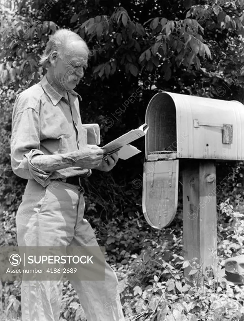 1940S Senior Farmer Reading Mail At Rural Free Delivery Mail Box