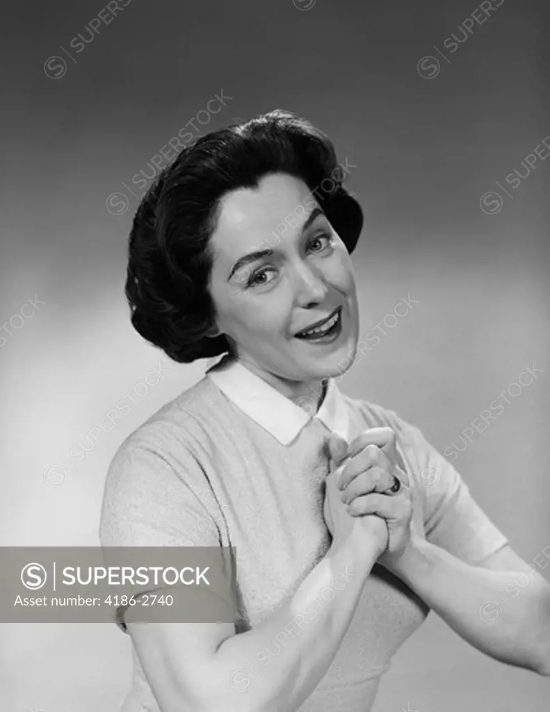 1950S Brunette Woman Smiling Happy Satisfied Proudly Clasping Hands To Chest