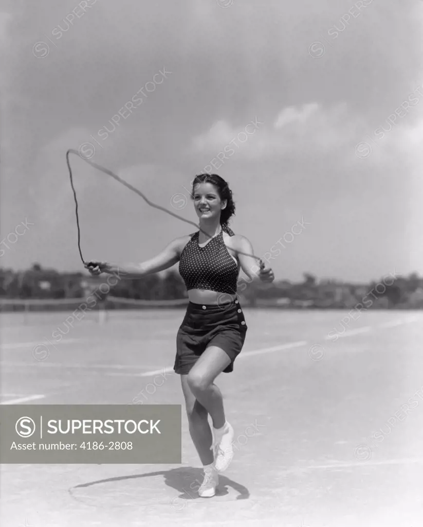 1930S Woman Jumping Rope Exercise Outdoors Wearing Polk Dot Halter Top And Shorts