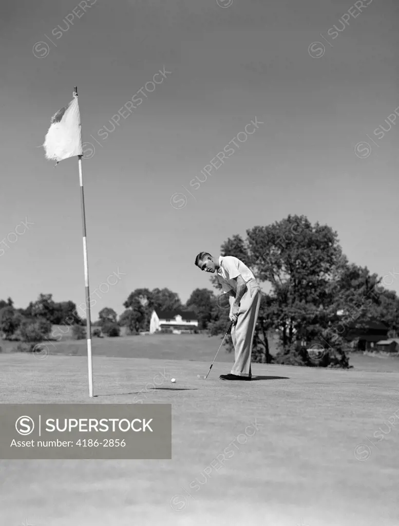 1950S Man Playing Golf Putting Golf Ball On Green To Flag And Cup Outdoor