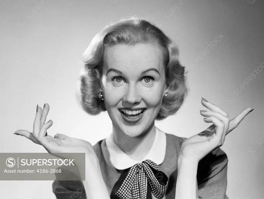 1950S Smiling Blonde Portrait Female Palms Up Index Fingers Extended