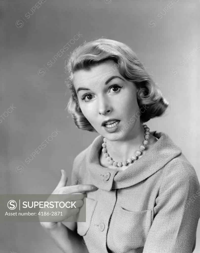 1950S Woman Pointing To Herself Quizzical Expression Indoor