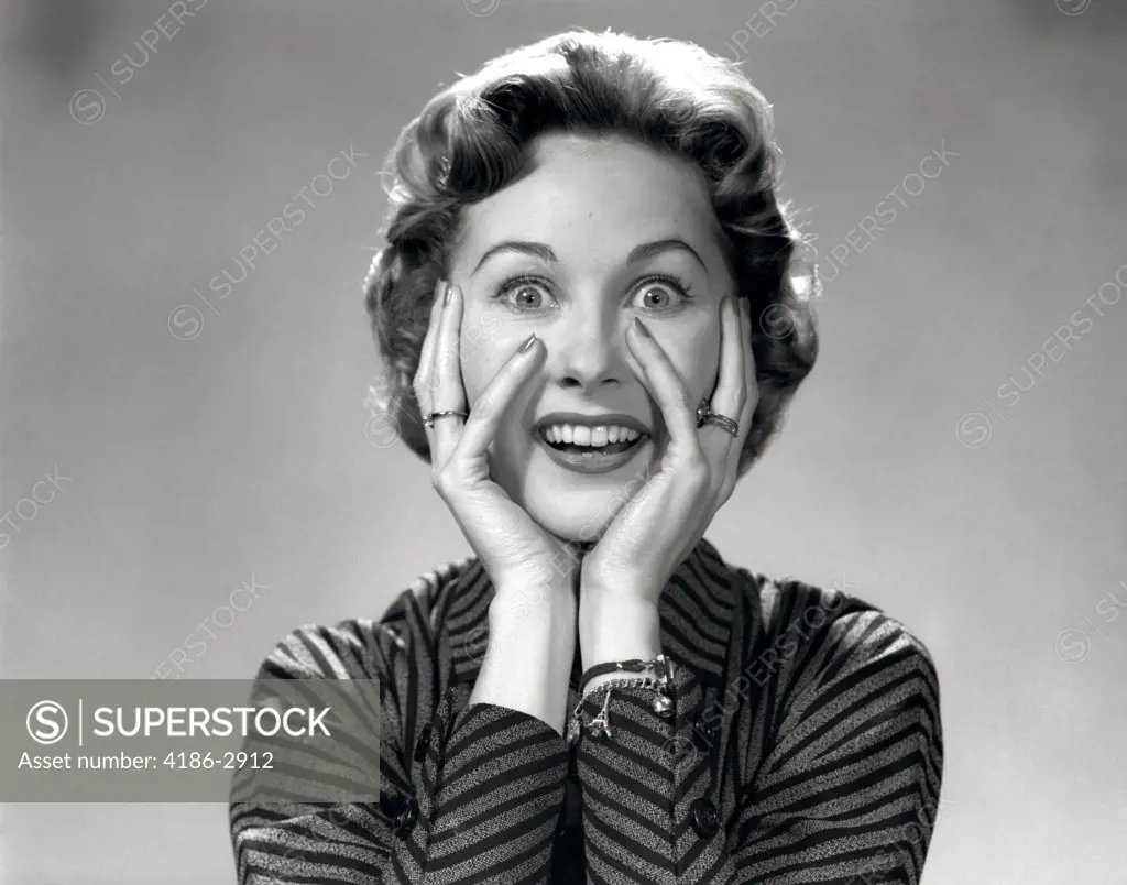 1950S 1960S Portrait Of Wacky Woman Hands On Face With Smiling Excited Happy Funny Face Surprised Expression Looking At Camera