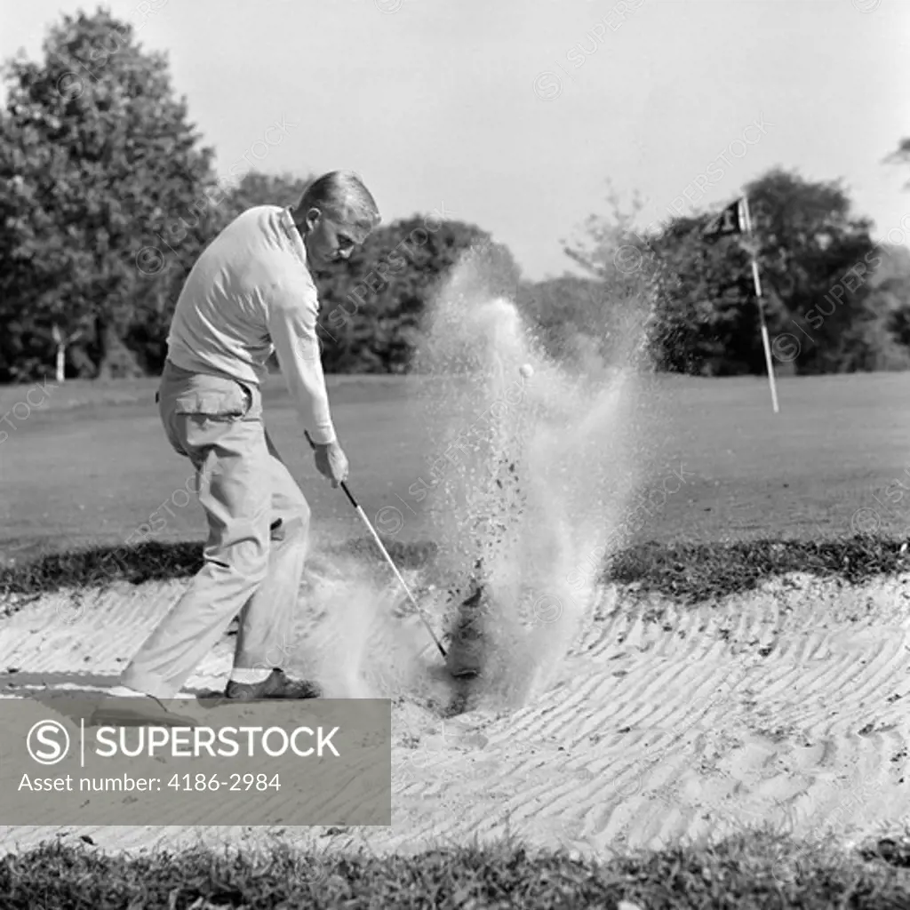 1960S Man Playing Golf Chipping Golf Ball Out Of A Sand Trap