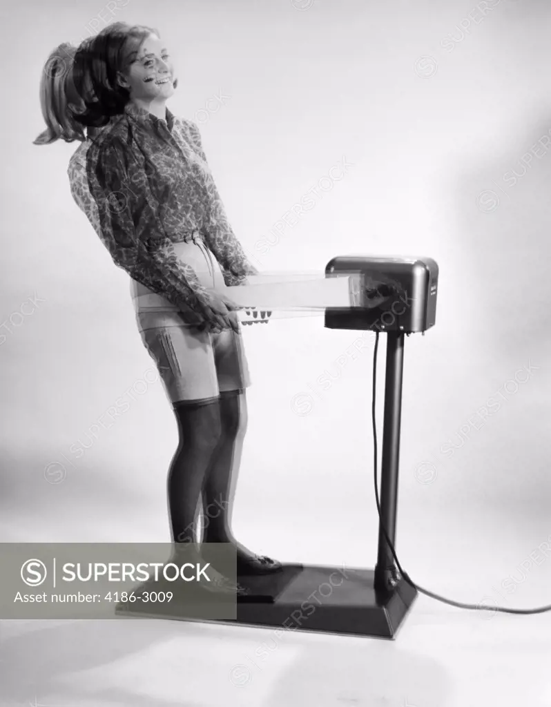 1960S Woman Massaged By Vibrating Exercise Machine