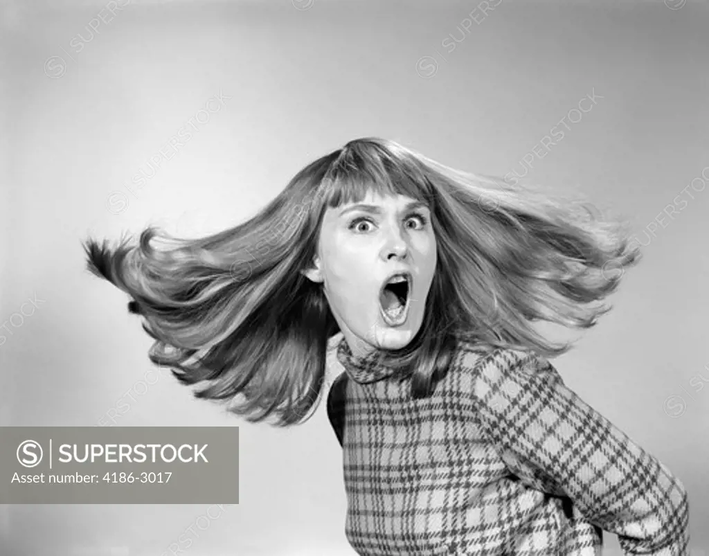 1960S Portrait Of Woman With Mouth Wide Open And Hair Flying