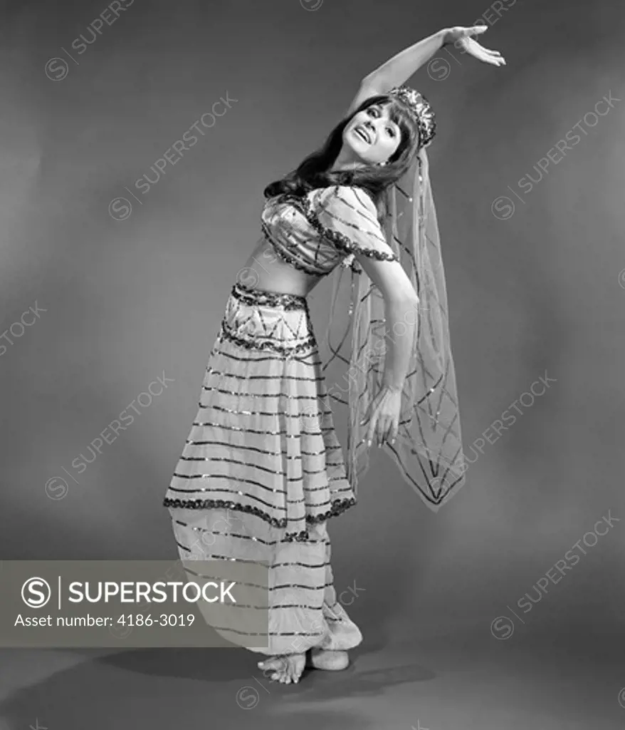 1960S Woman In Belly-Dancer Costume Stretching Back With Arms Out