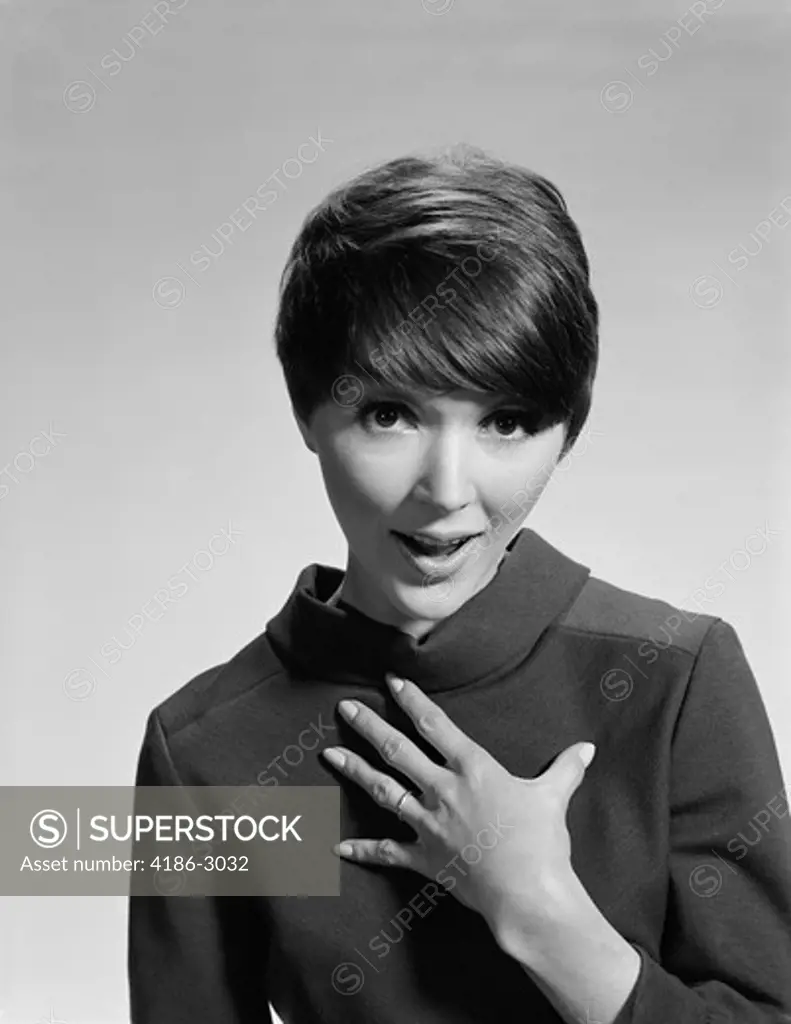1960S Brunette Woman Hand To Chest Questioning Quizzical Express Who Me