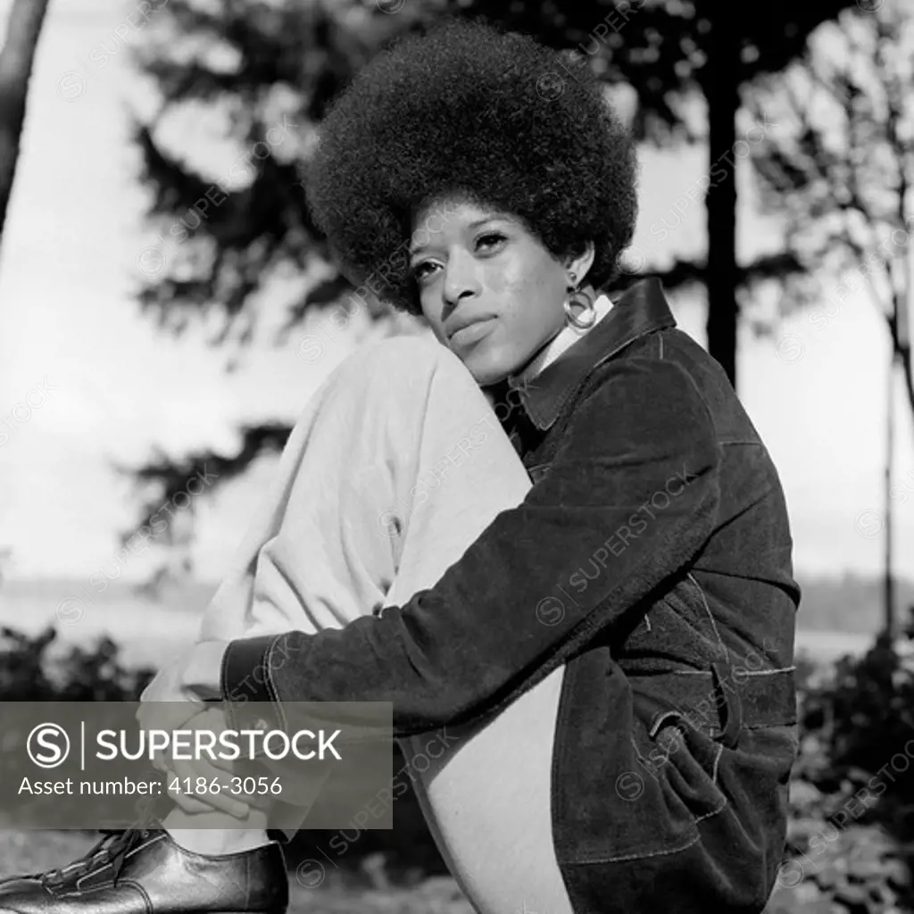 1970S Portrait African American Woman Seated Legs To Chest With Cheek Resting On Knee Looking Off Into Distance