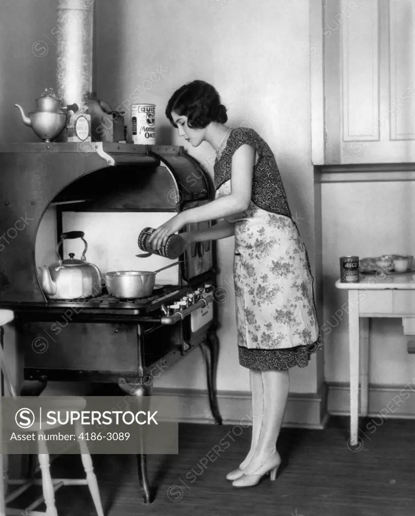 1920S Housewife At Stove Cooking