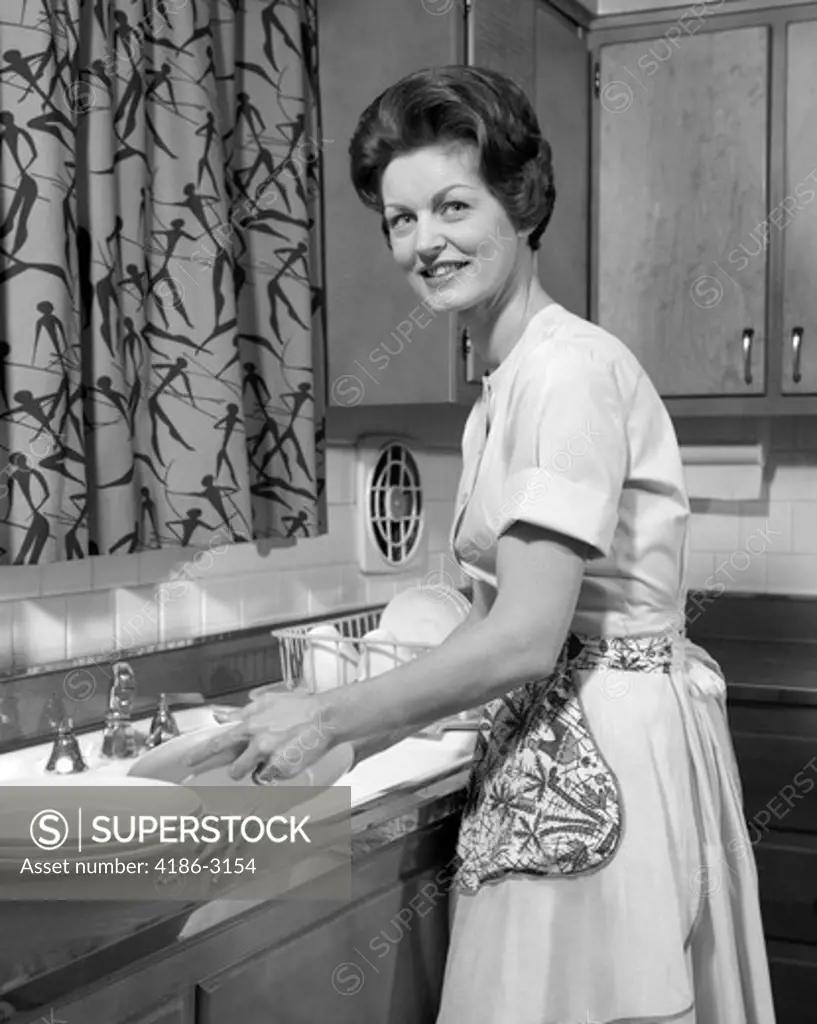 1960S Woman Housewife Washing Dishes  In Kitchen Sink