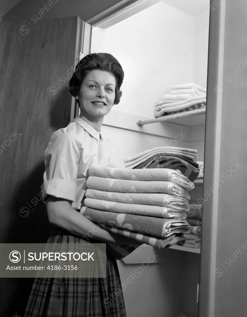 1950S 1960S Housewife Holding Laundry Folded Towels By Linen Closet