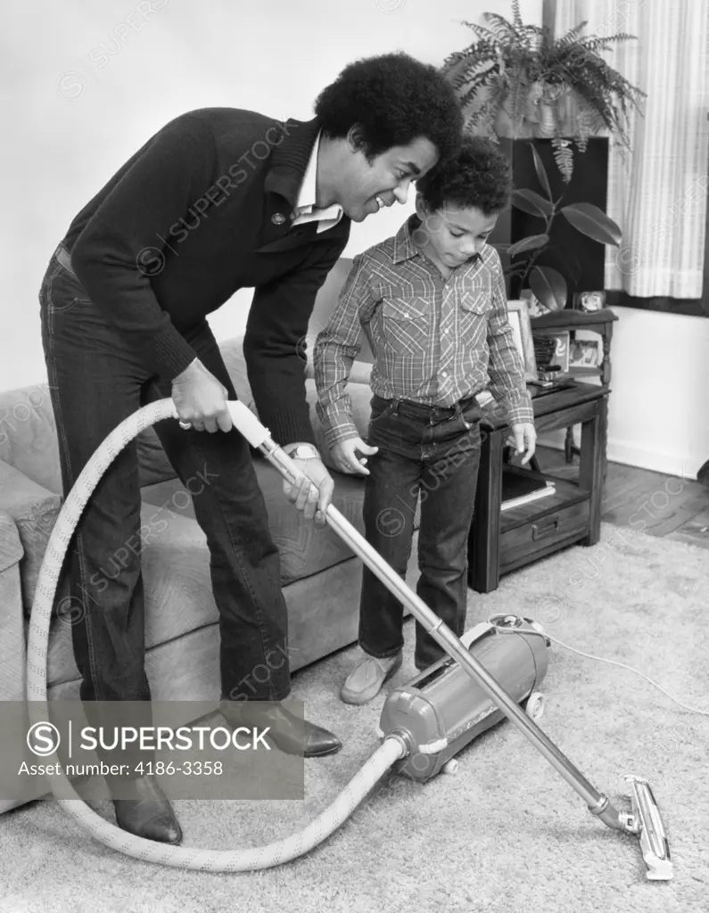 1970S 1980S African American Man Father And Son Boy Vacuuming Carpet Vacuum