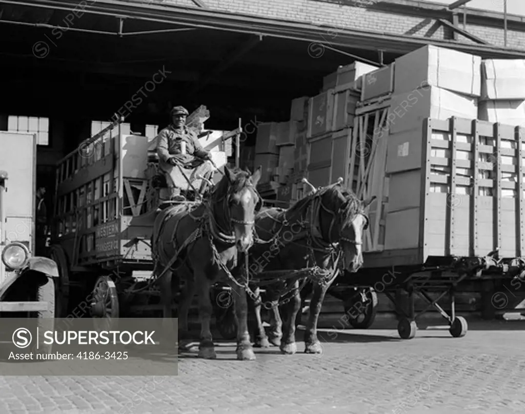 Turn Of The Century African American Man Pulling Wagon Drawn By Two Horses Out Of Truck Terminal