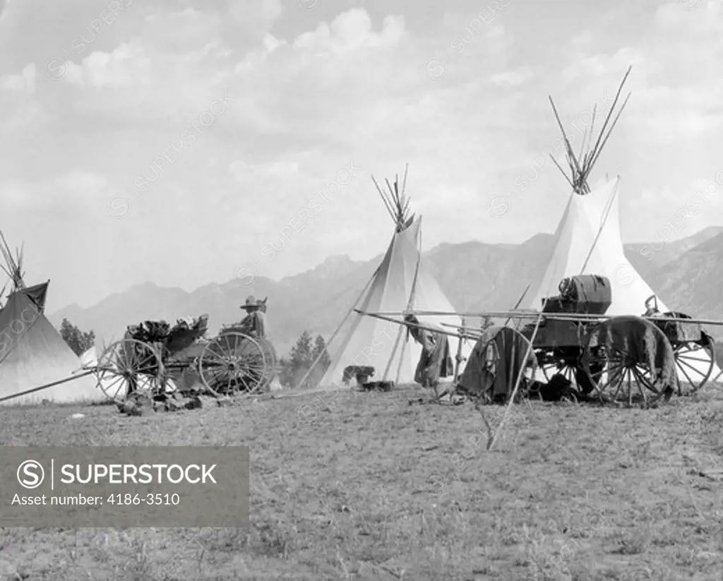 1920S 1930S Indigenous Kootenai Indigenous Camp Village Tipi Wagons Mountains In Background British Columbia, Canada