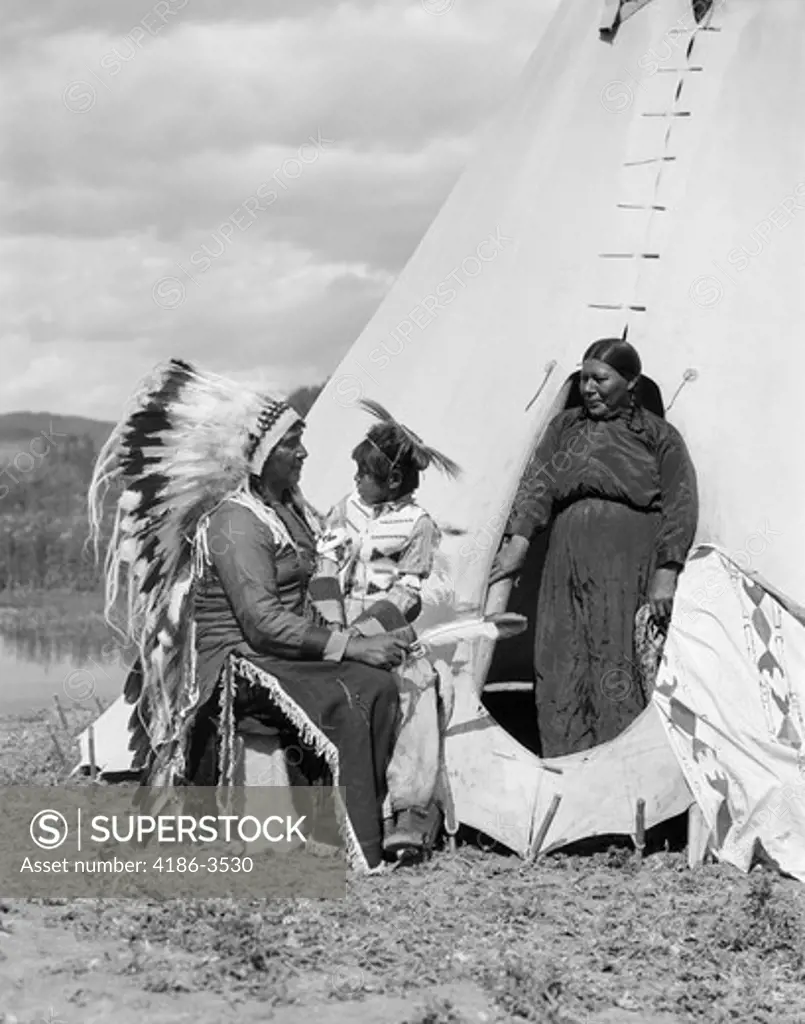 1920S Native American Indian Family Man Woman Child By Tepee Stoney Sioux Tribe Near Alberta Canada