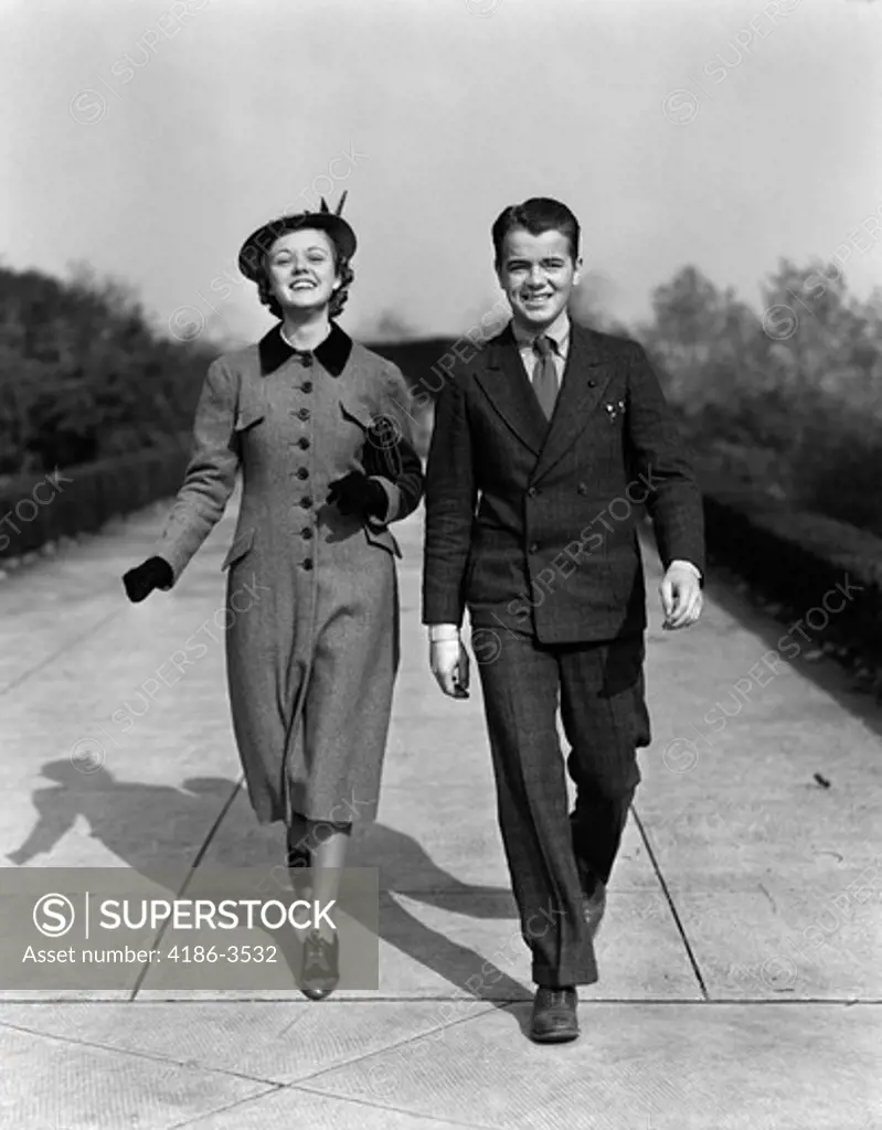 1940S Young Smiling Teenage Couple Walking On Sidewalk Smiling Dressed Up Sunday Best