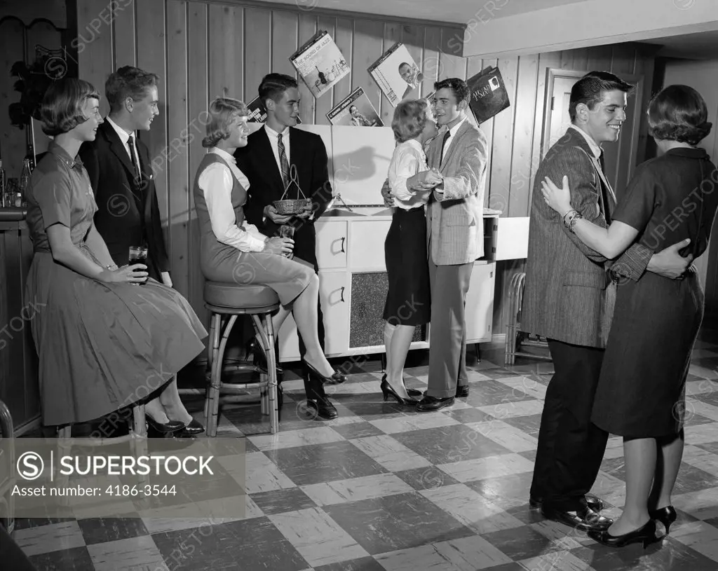 1950S 1960S Teen Couples Having Party Dancing In Rec Room