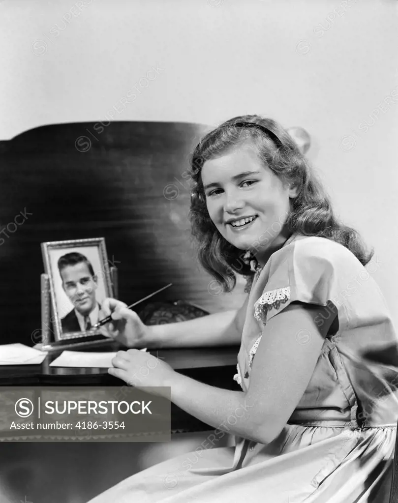 1940S Smiling Girl At Desk Writing Letter Photo Of Boy Or Man In Frame