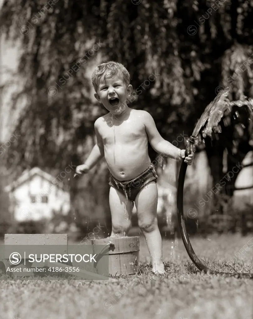 1940S 1950S Wet Young Boy Toddler Outside Playing With Water Hose