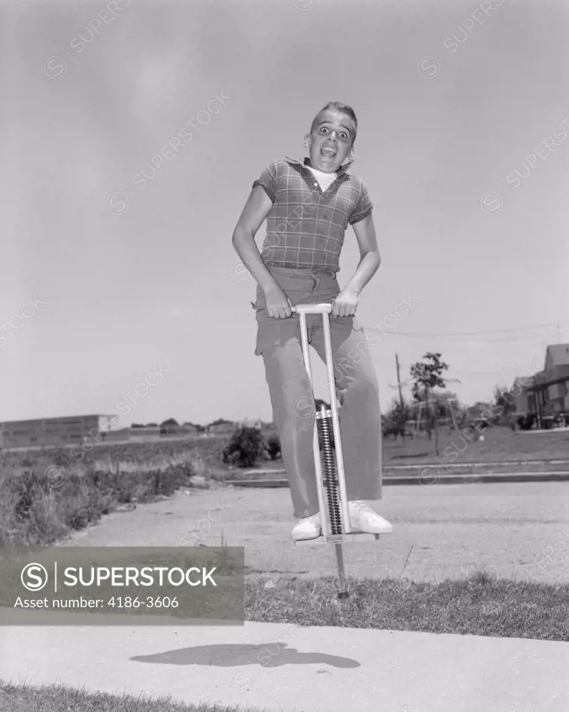 1950S Boy Jumping On Pogo Stick