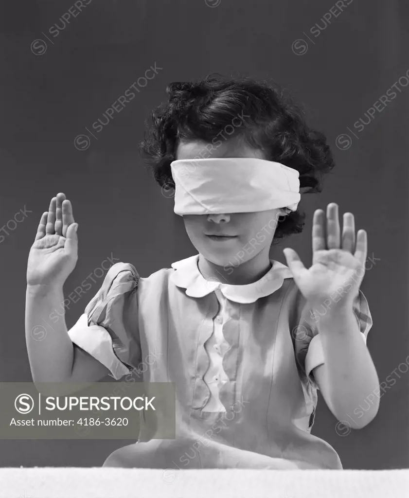 1940S Child Wearing Blind Fold With Hands Up In The Air