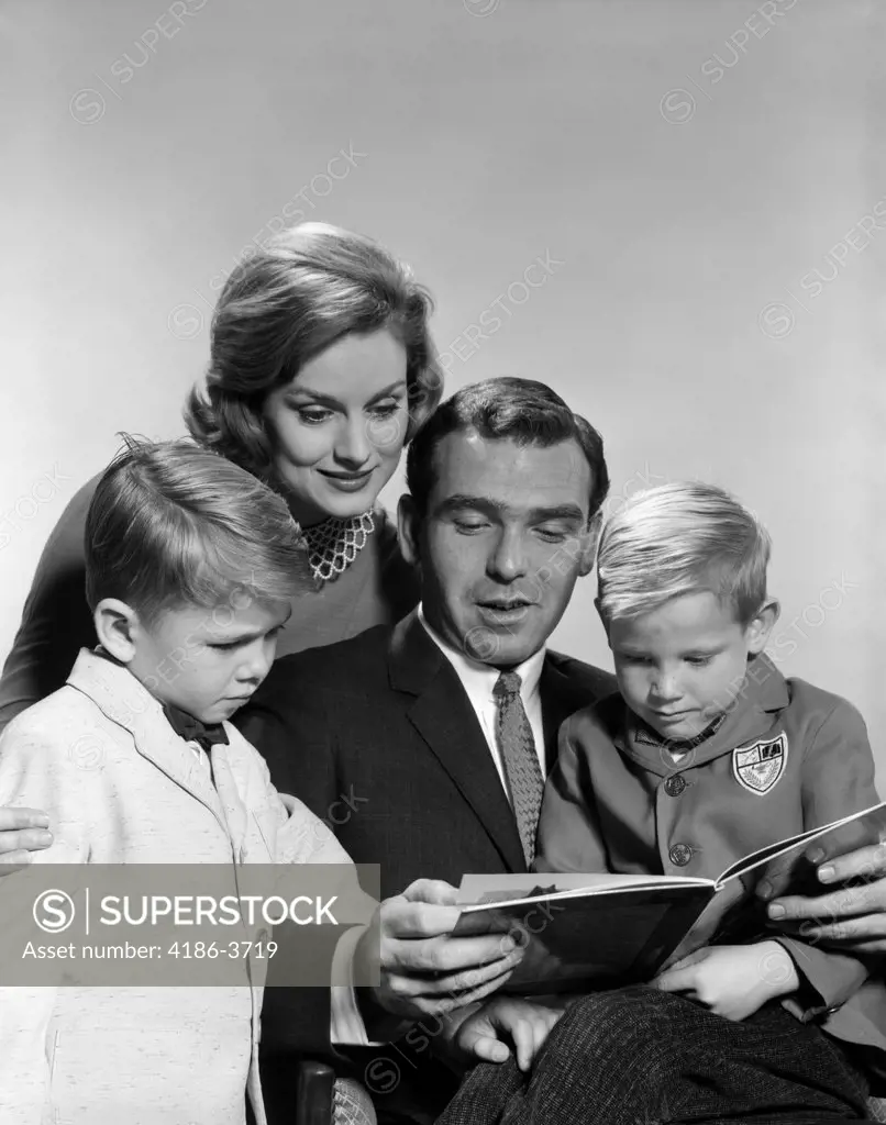 1960S Family Father Mother Sons Reading Book Together