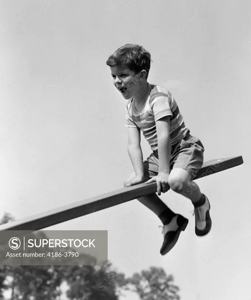 1930S 1940S Excited Boy On Seesaw Playing