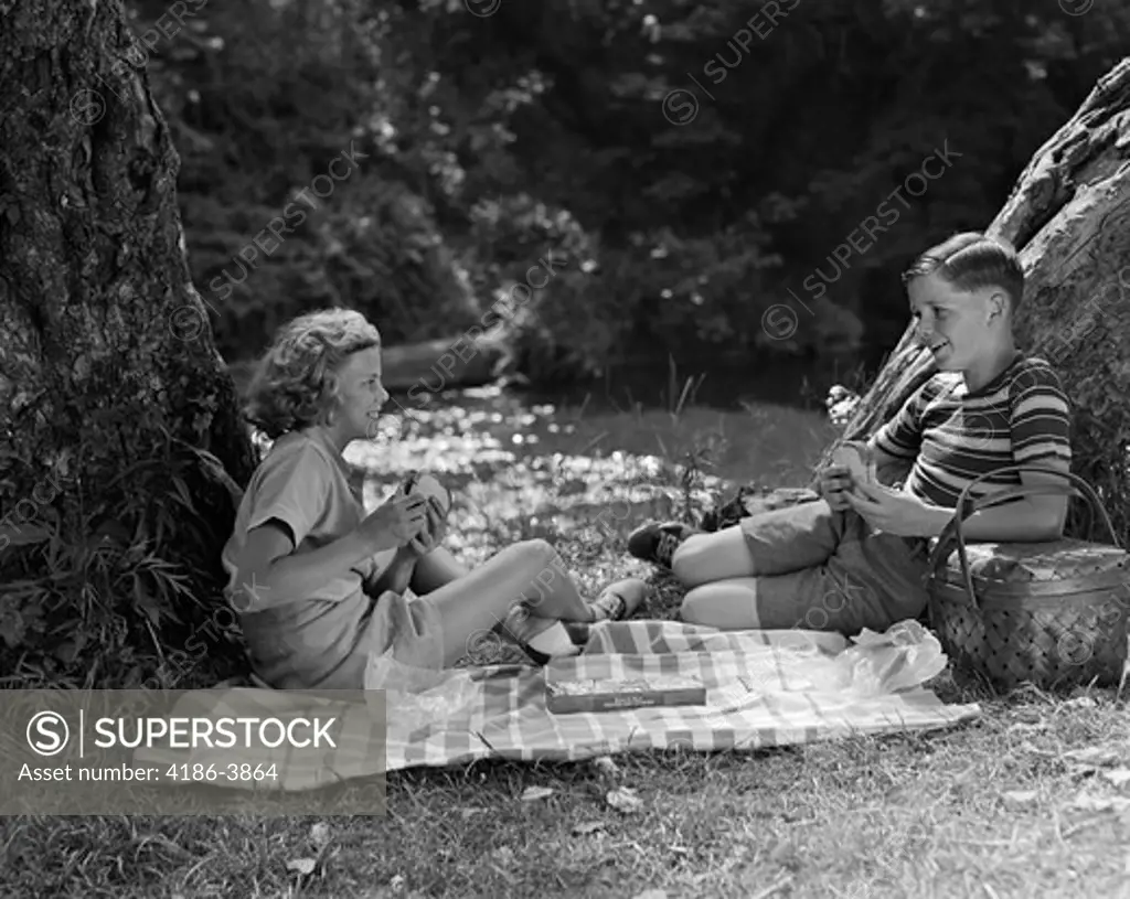 1940S Boy And Girl Having Summer Picnic By Stream