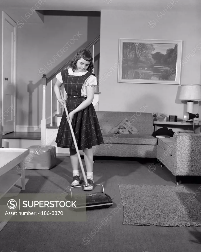1950S Girl Using Non Electric Vacuum Clean Carpet Living Room Chore Fashion Sweeper Wearing Jumper