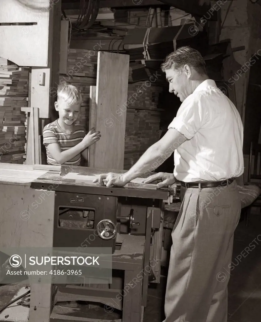 1930S 1940S 1950S Man Father Cutting Wood Board On Table Saw Teaching Boy Son Carpentry