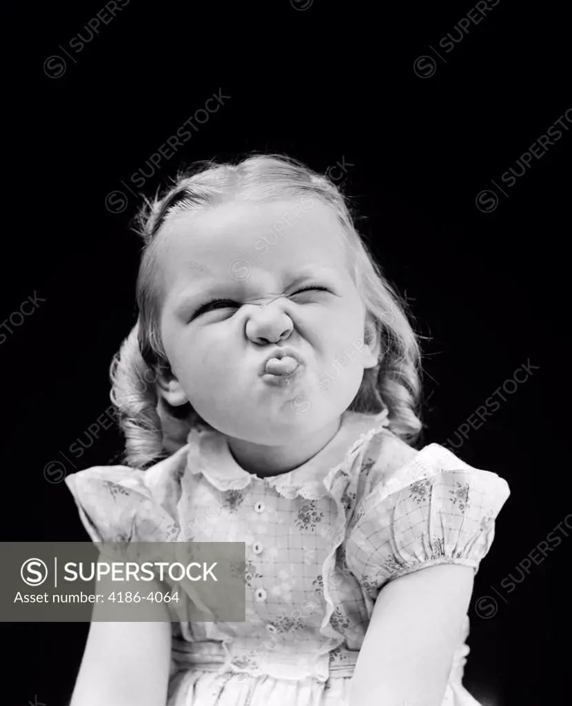 1940S Portrait Of Girl Sticking Out Tongue Studio