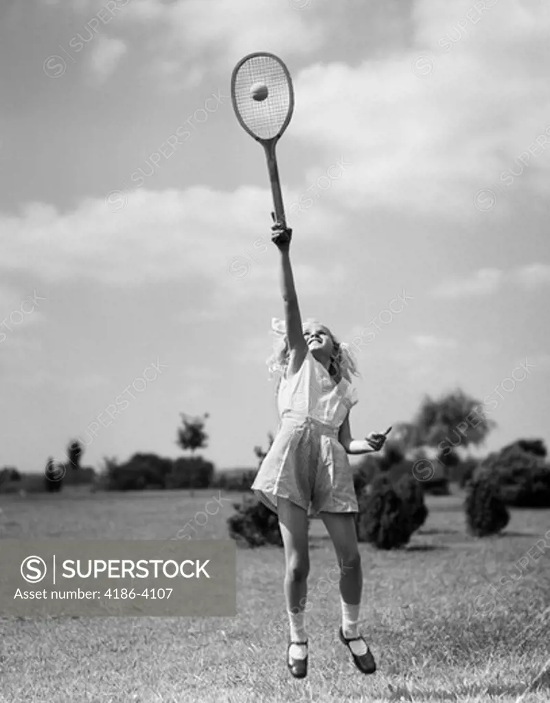 1930S Girl Playing Tennis Jumping To Hit Ball Overhead