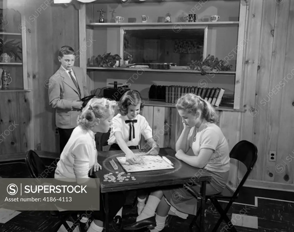 1950S Girls Playing Scrabble In Rec Room With Boy Changing Records