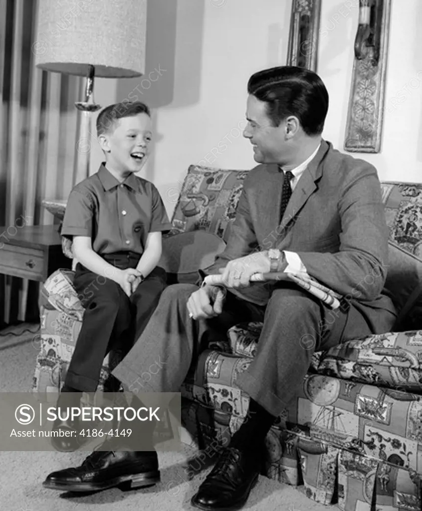 1960S Boy Sitting On Couch Smiling Laughing With Dad  
