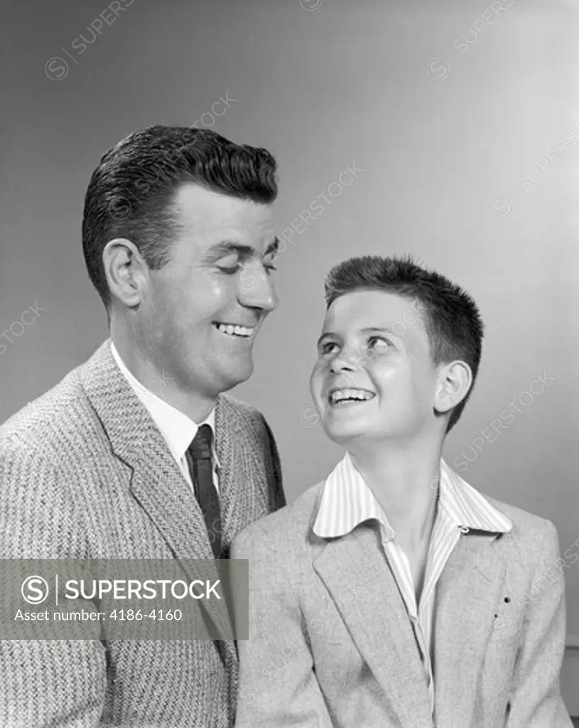 1950S Father Smiling At Son Studio Portrait